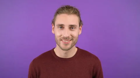 Man with a beard with a smile looks at the camera and shows a hand gesture of Stock Footage 147217873