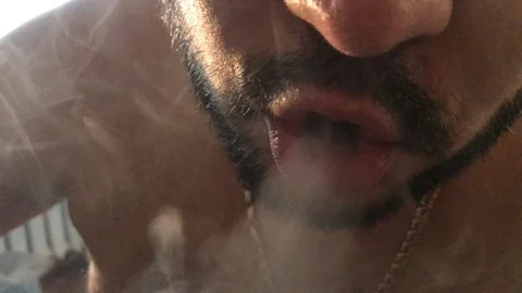 Man with a beard smokes a hookah 動画素材 105923984