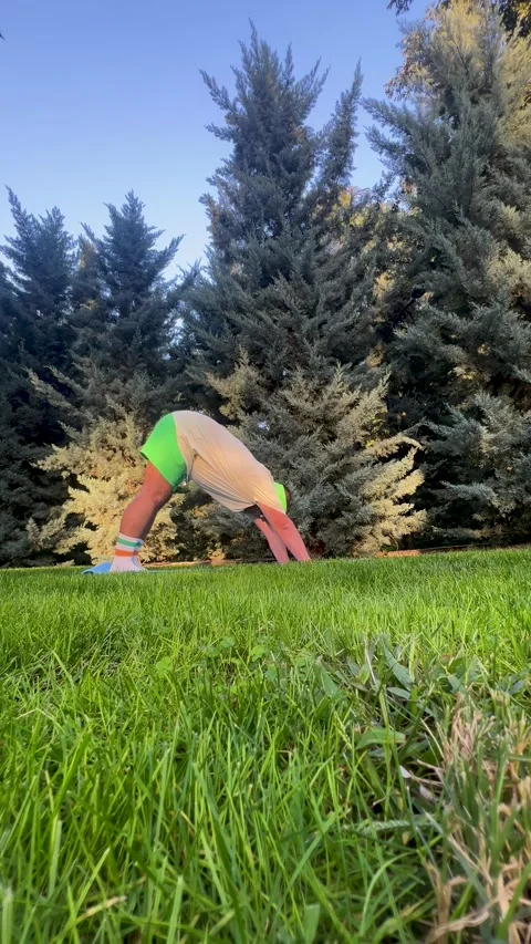 Man with beard stands Downward Dog pose Stock Footage 321852629