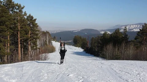 Man with a beard in sunglasses with a backpack rising uphill Stock Footage 74699245