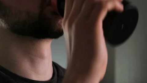 A man with a beard takes a sip from a shaker Stock Footage 169050923