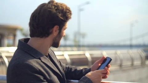 Man with a beard taking a picture of the bright traffic road Stock Footage 117433823