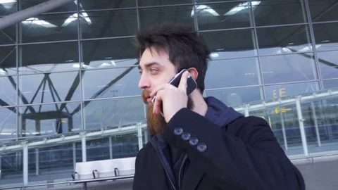 Man with Beard talk at telephone outside airport, slow motion Stock Footage 74166636