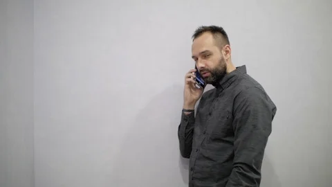 Man with beard talking on the phone Stock Footage 98808682