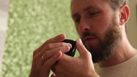 A man with a beard is a tea lover drinking Chinese tea from a bowl Stock Footage 220537014