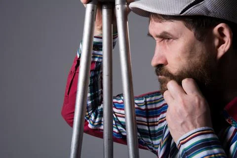 Man with beard a tripod thoughtfully Stock Photos