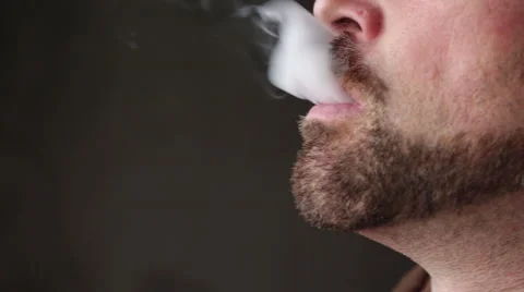 Man with Beard Vapes Smokes an E-Cigarette - Close Up Jaw Stock Footage 46062146