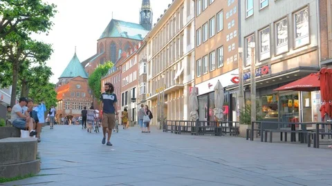 Man with a beard walking on pedestrianized street Stock Footage 76481489
