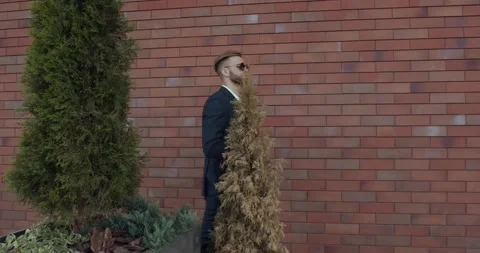 Man with a beard walks down the street, elegant and luxuriously dressed Stock Footage 140197952