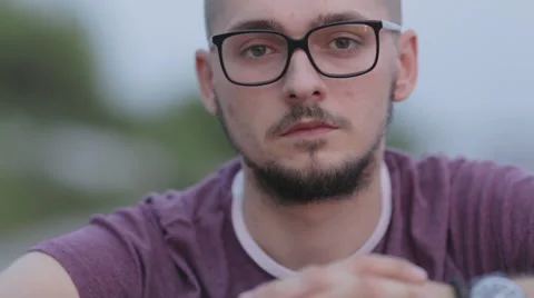 A Man With A Beard Wearing Glasses Looking Into The Camera Stock Footage 53278086