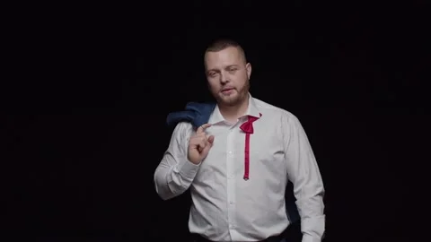A man with a beard in a white shirt with an unbuttoned bow tie and a jacket  Stock Footage 194120210