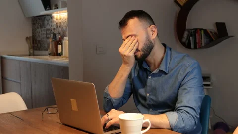 Man with beard working on computer. Tired feeling fatigue and headache. Stock Footage 171615534