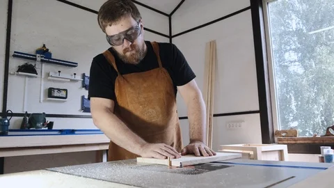 A man with a beard works in his workshop. Profession carpenter. A man works with Stock Footage 113994256