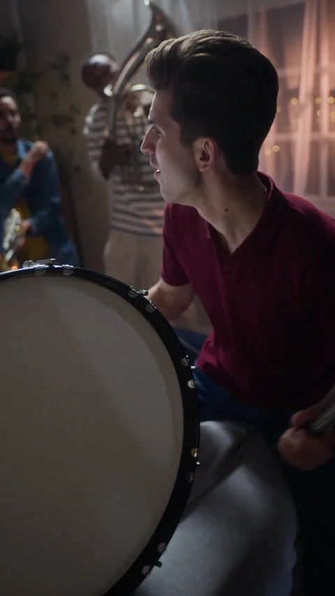 Man Beating Bass Drum Celebrating Match with Friends at Home Stock Footage 344648659