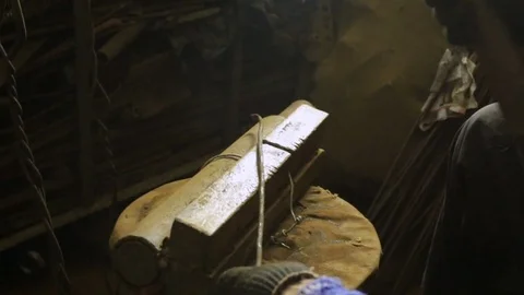 The man beats the hammer on the anvil. Left-side view. The person aligns the met Stock Footage 83073555