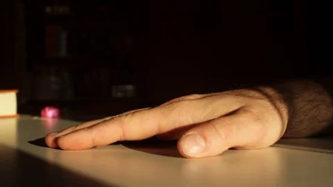 Man beats his hand on the table Stock Footage 75061319