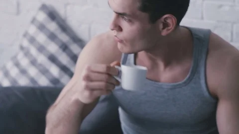 Man in bed with a cup Stock Footage 76509855