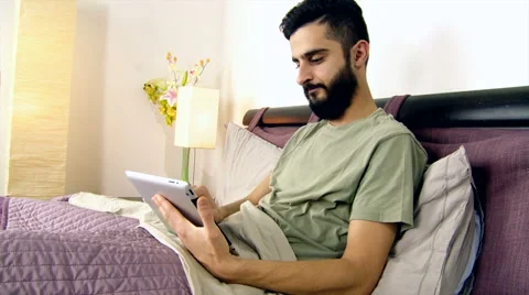 Man in bed enjoying tablet in the morning at home Stock Footage 44477165