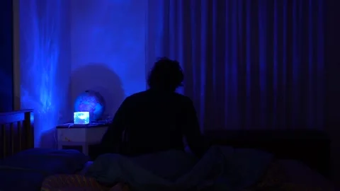 Man in bed has trouble falling asleep, insomnia and sleep problems lead to daily Stock Footage 326626286