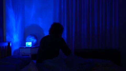 Man in bed has trouble falling asleep, insomnia and sleep problems lead to daily Stock Footage 326626304