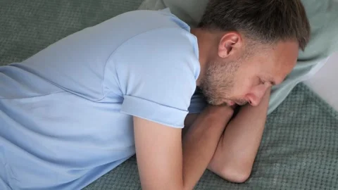 Man in bed lying with open eyes, top view. Insomnia problems with sleep or Stock Footage 260888347