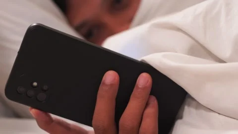 Man in bed at night using a mobile phone. Stock Footage 337208515