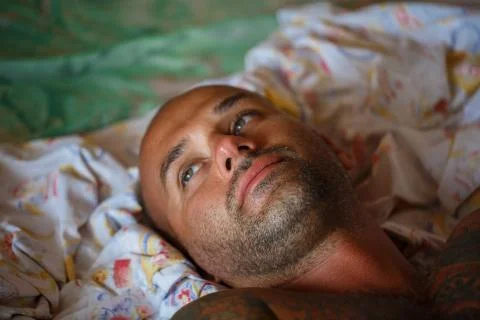 Man on the bed Stock Photos