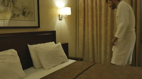 The man on the bed with the remote Stock Footage 64765015