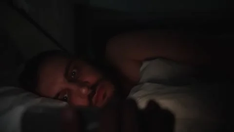 Man In Bed Scrolling Phone At Night Tech Addiction And Sleeplessness Stock Footage 321380332