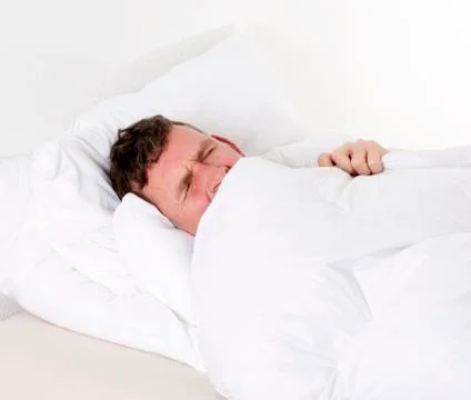 Man in bed sleeping Stock Photos