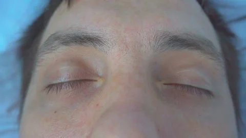 Man on the bed slowly opens his eyes. Stock Footage 96336567