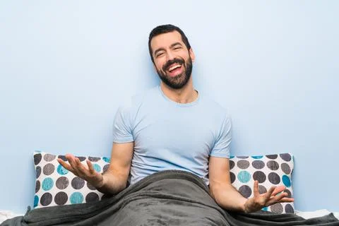 Man in bed smiling Stock Photos