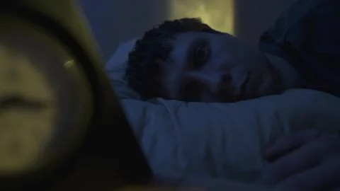 Man in bed staring into space, close-up. Sleepless night concept, mental stress Video stock 320187599