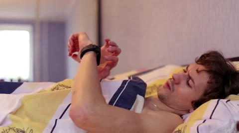 The man in bed using smart watches Stock Footage 61168265