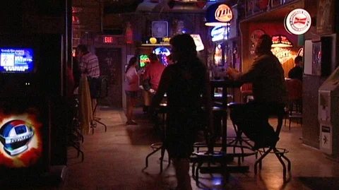 Man with Beer Bottle Sitting at Table in Harold's Club Stock Footage 105956980