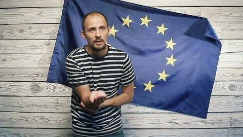 A man begging on the background of the EU flag Stock Footage 95846275