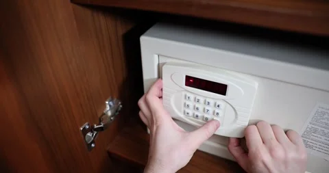 Man begins to enter hotel safe code using digit buttons Video stock 307906306