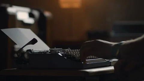 A man begins to write at an old vintage typewriter Stock Footage 97872855
