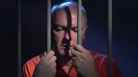 Man behind bars reflecting on his crime 스톡 동영상 21253627