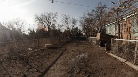 The Man Behind The Camera Pours Dirty Water on the Ground in a Remote Rural Stock Footage 59614732