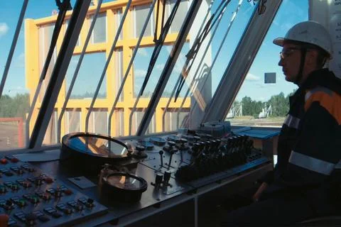 The man behind the control panel. Levers for controlling hydraul Stock Photos