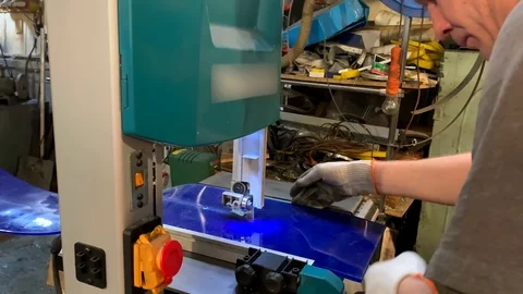 Man behind the machine - a band saw cuts a polyurethane plate Video stock 118518596