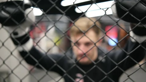 Man behind the octagon mesh getting ready for fight. Stock Footage 263154006