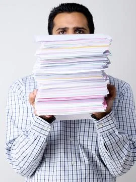 Man behind by stack of papers MR#779K Stock Photos
