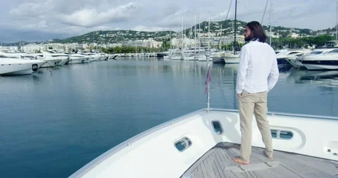 Man from behind standing on a boat sailing into the seagate, under the cloudy sk Stock-Footage 150179490