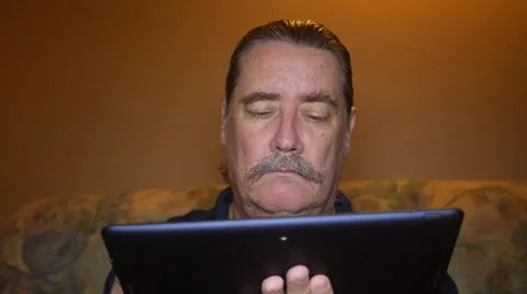 MAN BEHIND TABLET-IPAD on sofa Stock Footage 54190476