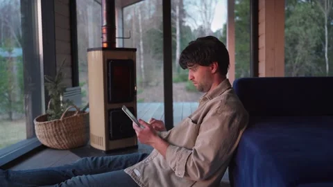 Man in a beige shirt using a digital tablet, reading the news, browsing social 스톡 동영상 245992000