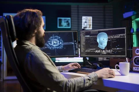 Man being asked existential questions by awaken AI on desktop PC Stock Photos