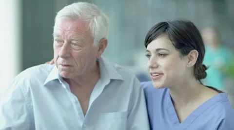 Man being comforted by caring nurses.  Assisting people when life throws 스톡 동영상 32961751