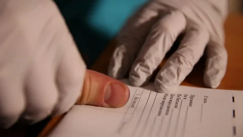 A man is being fingerprinted. Taking fingerprints from suspect. Closeup Stock Footage 86126379